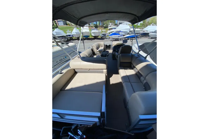 Slide: The Image of 2021 Sun Tracker Party Barge 22 DLX interior with spacious seating and canopy. - 4