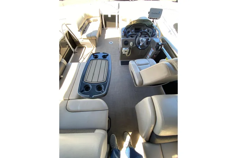 Slide: The Image of 2021 Sun Tracker Party Barge 22 DLX interior with seating and steering console. - 5