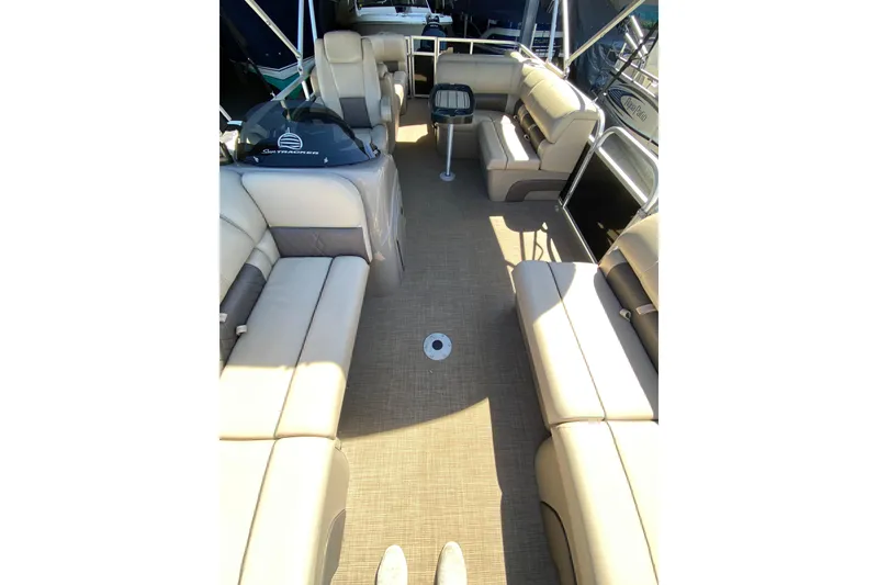 Slide: The Image of 2021 Sun Tracker Party Barge 22 DLX interior with beige seating and spacious layout. - 7