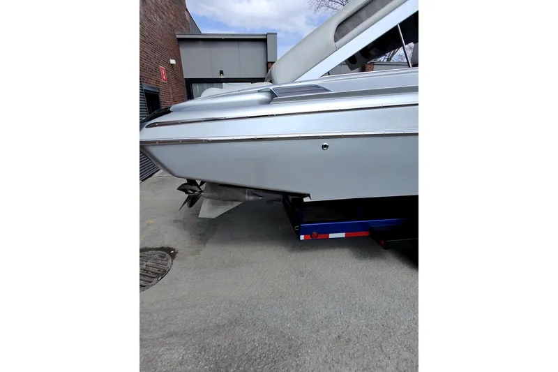 Slide: The Image of Monte Carlo 420 boat, 2017 model, on a trailer near a brick building. - 13