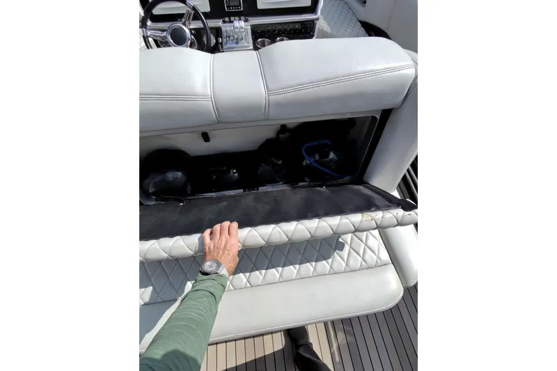 Slide: The Image of Person opening storage compartment on 2017 Monte Carlo 420 boat with quilted upholstery. - 20