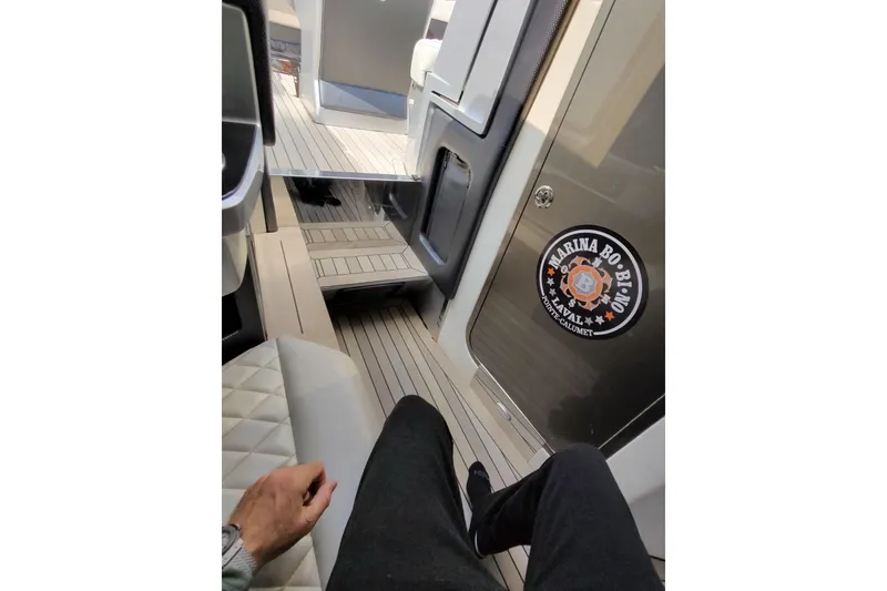 Slide: The Image of Interior view of a 2017 Monte Carlo 420 yacht with sleek seating and flooring. - 24