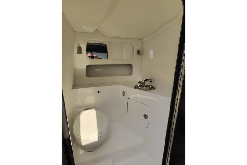 Slide: The Image of Compact bathroom in 2017 Monte Carlo 420 yacht with toilet, sink, and mirror. - 25
