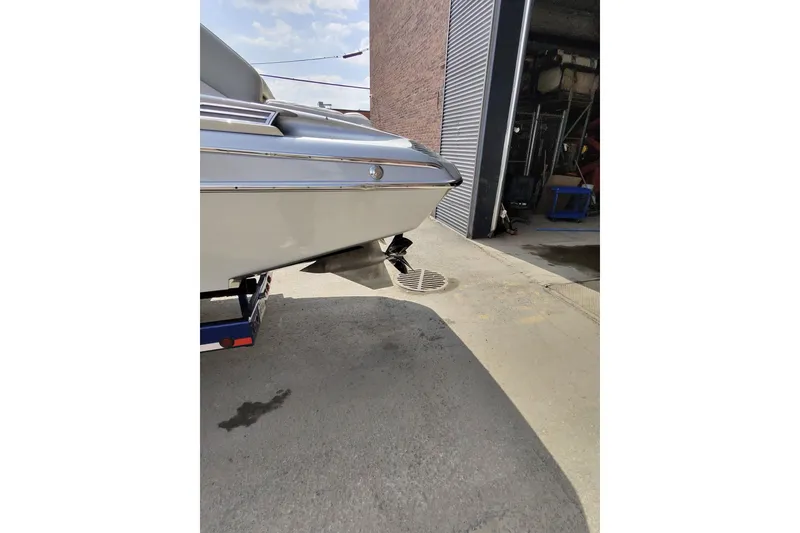 Slide: The Image of Monte Carlo 420 boat from 2017 on a trailer near a garage. - 28