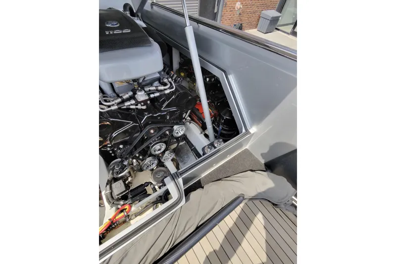 Slide: The Image of Engine compartment of a 2017 Monte Carlo 420 boat, showcasing mechanical components. - 33