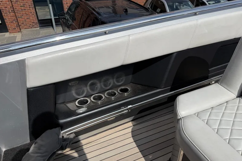 Slide: The Image of Interior of a 2017 Monte Carlo 420 boat, featuring sleek seating and cup holders. - 44
