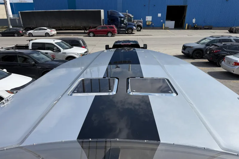 Slide: The Image of Top view of a 2017 Monte Carlo 420 boat with a sleek black stripe design. - 55