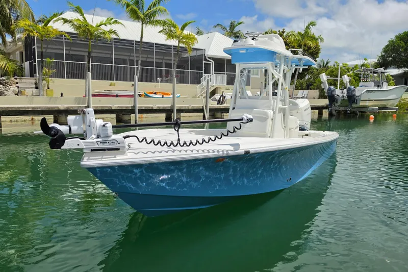 The Image of 2025 SeaVee 270Z boat docked in a sunny marina with palm trees. - 1