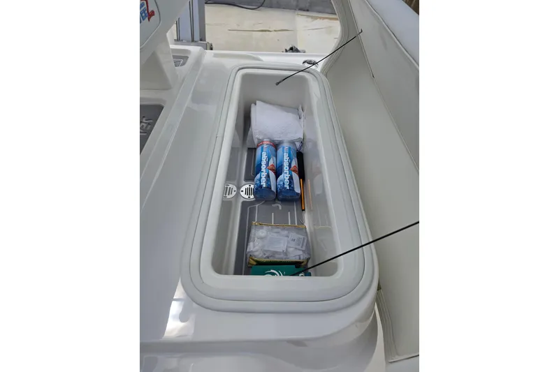 Slide: The Image of Storage compartment on 2025 SeaVee 270Z boat, holding drinks and supplies. - 10