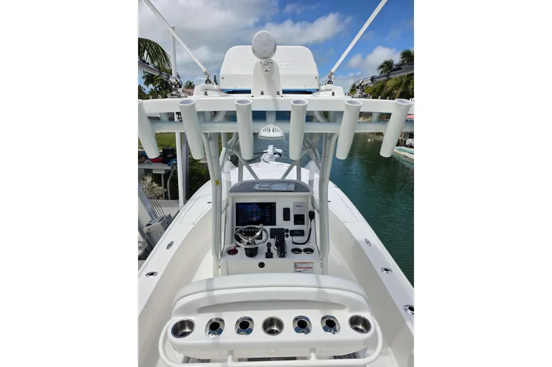 Slide: The Image of 2025 SeaVee 270Z boat console with rod holders, steering wheel, and navigation equipment. - 12