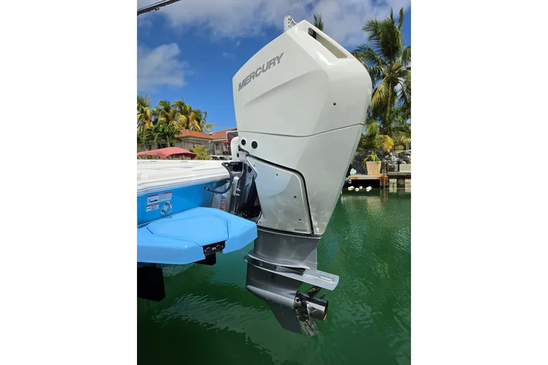 Slide: The Image of 2025 SeaVee 270Z boat with Mercury outboard motor, docked in tropical setting. - 13