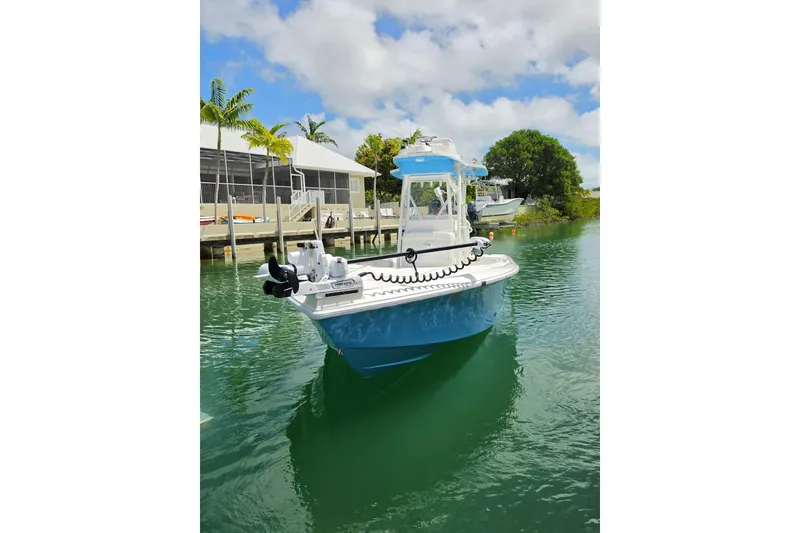 Slide: The Image of 2025 SeaVee 270Z boat docked on calm water under a blue sky. - 15
