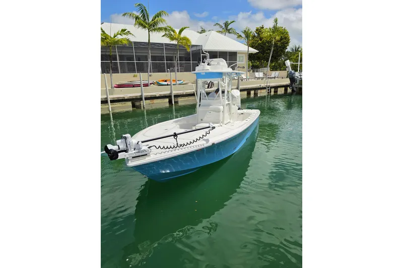 Slide: The Image of 2025 SeaVee 270Z boat docked in a marina with palm trees and clear skies. - 3