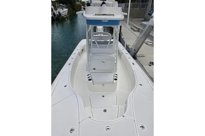 Slide: The Image of 2025 SeaVee 270Z boat, sleek white deck, docked by calm waters. - 4