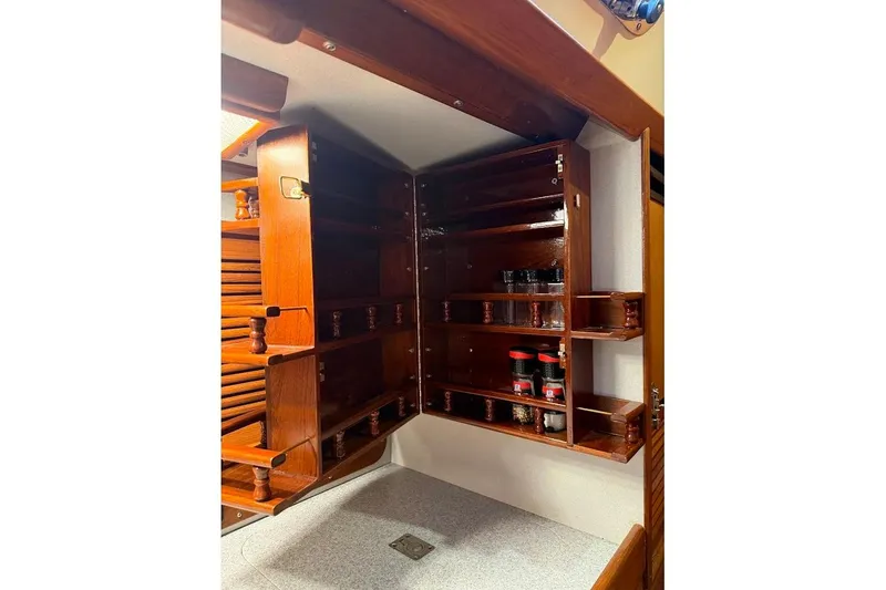 Slide: The Image of Interior of 1997 Taswell 50 yacht with wooden cabinetry and spice jars. - 10