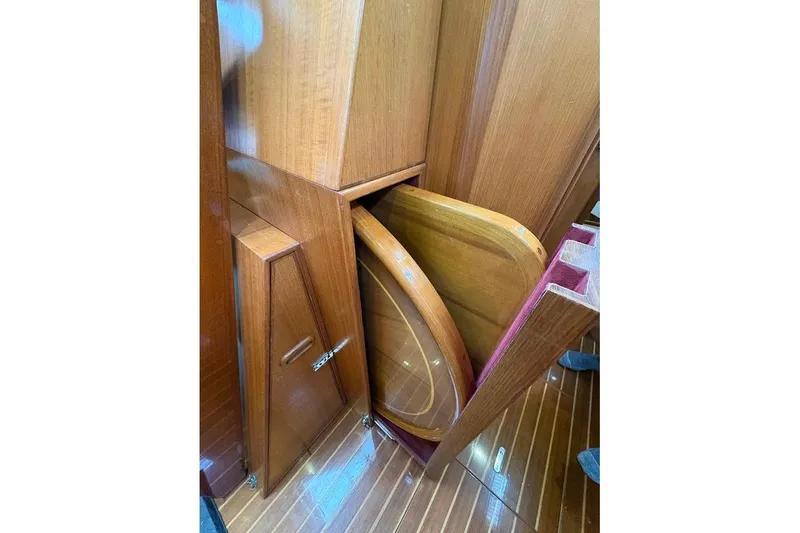 Slide: The Image of Interior of 1997 Taswell 50 yacht showcasing wooden cabinetry and storage compartments. - 11
