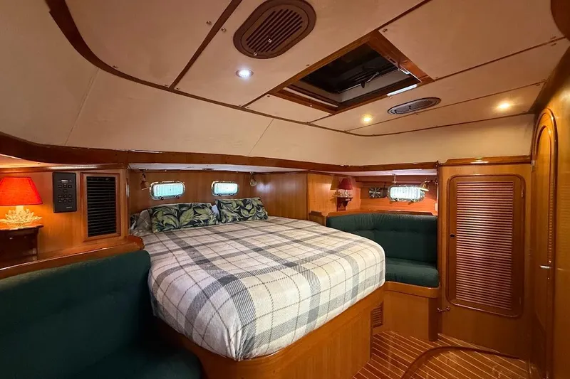 Slide: The Image of Luxurious 1997 Taswell 50 yacht cabin with cozy bed and elegant wood finish. - 12