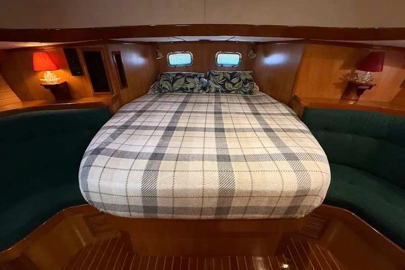 Slide: The Image of Cozy cabin interior of 1997 Taswell 50 yacht with plaid bedding and wooden finish. - 13