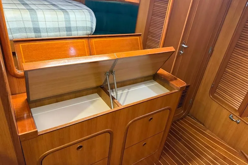 Slide: The Image of Interior of 1997 Taswell 50 yacht with open wooden storage compartments. - 15