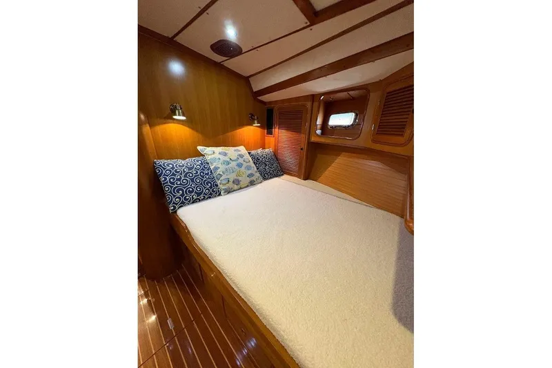 Slide: The Image of Cozy cabin interior of 1997 Taswell 50 yacht with wooden finish and decorative pillows. - 18
