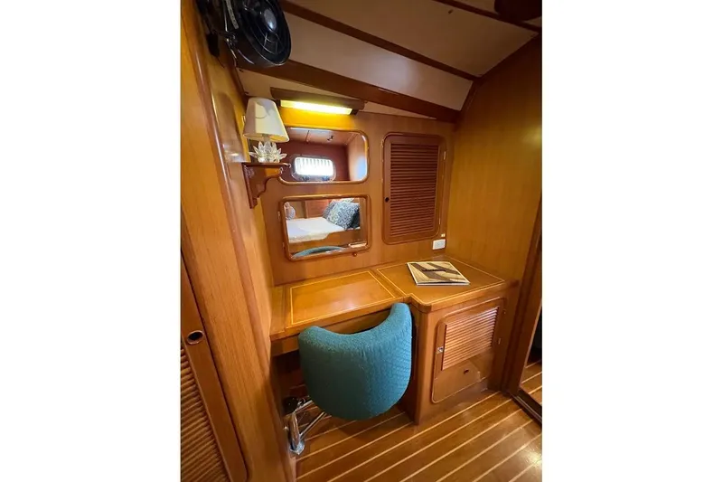 Slide: The Image of Cozy cabin interior of 1997 Taswell 50 yacht with wooden desk and teal chair. - 19