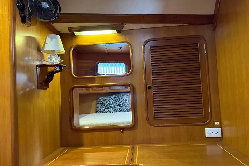 Slide: The Image of Interior of 1997 Taswell 50 yacht with wooden paneling and cozy cabin features. - 20