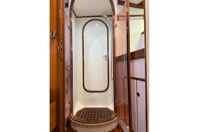 Slide: The Image of Shower area in 1997 Taswell 50 yacht with wooden accents and glass door. - 23