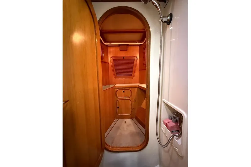 Slide: The Image of Interior of 1997 Taswell 50 yacht, featuring wooden cabinetry and shower area. - 24