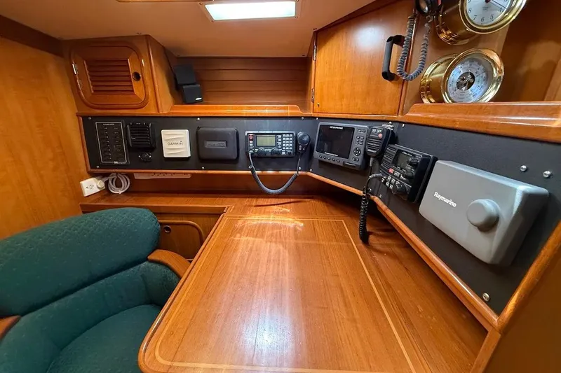 Slide: The Image of Navigation station of a 1997 Taswell 50 yacht with communication equipment and wooden interior. - 27