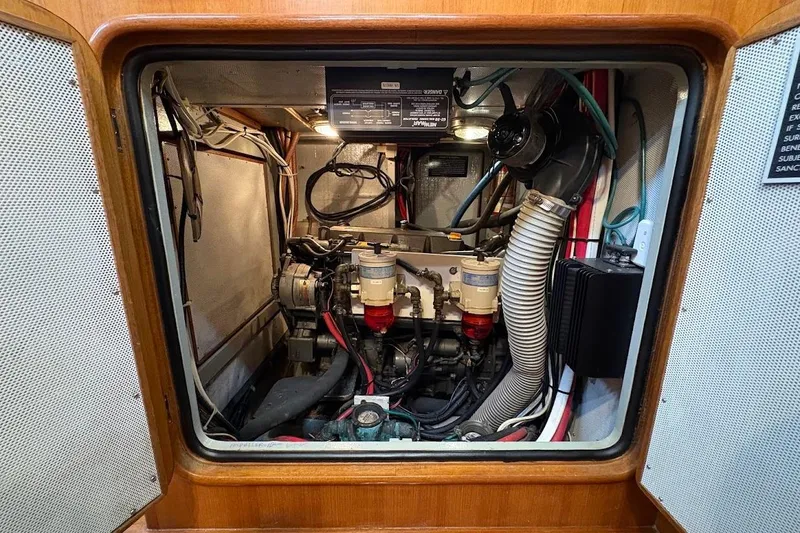 Slide: The Image of Engine compartment of a 1997 Taswell 50 yacht, showcasing mechanical components and wiring. - 31
