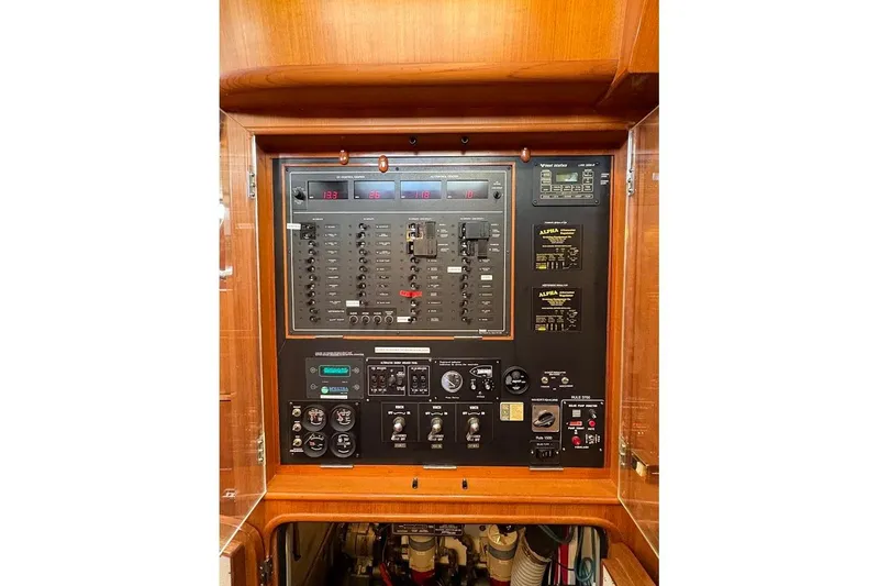Slide: The Image of Electrical control panel on a 1997 Taswell 50 yacht, featuring switches and gauges. - 32