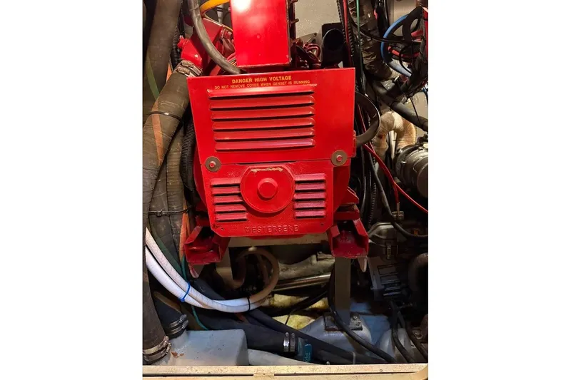 Slide: The Image of Engine compartment of a 1997 Taswell 50 sailboat with red Westerbeke generator. - 36