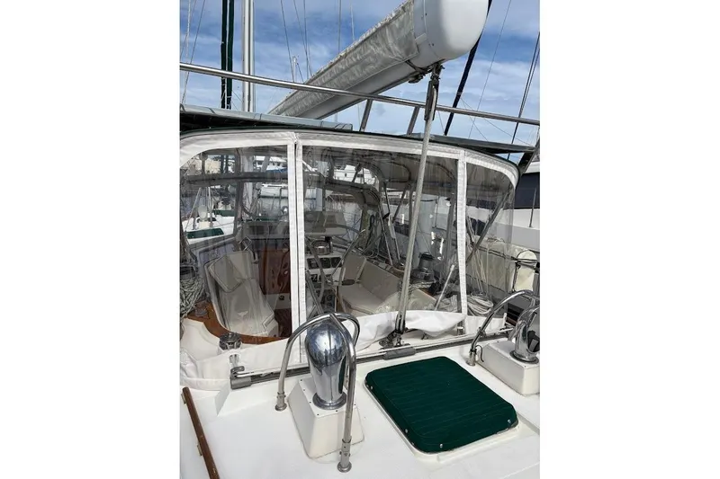 Slide: The Image of 1997 Taswell 50 sailboat cockpit with clear enclosure and polished metal fittings. - 44