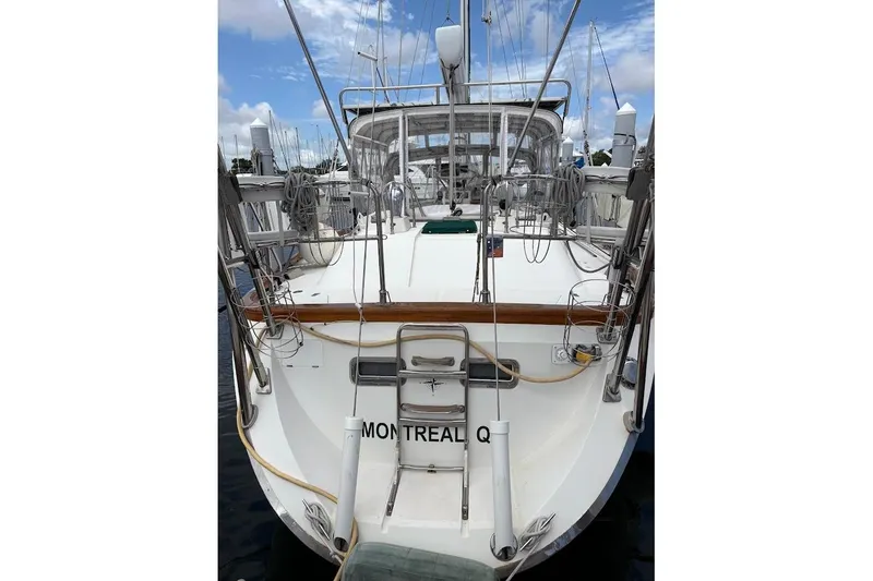 Slide: The Image of Stern view of 1997 Taswell 50 sailboat docked, featuring deck and rigging. - 46
