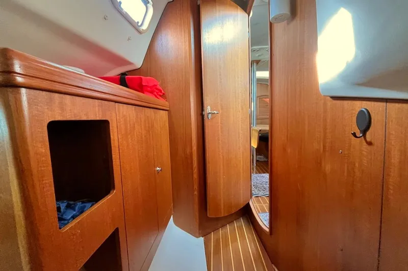 Slide: The Image of Interior of a 2002 Hunter 326 sailboat with wooden cabinetry and door. - 20