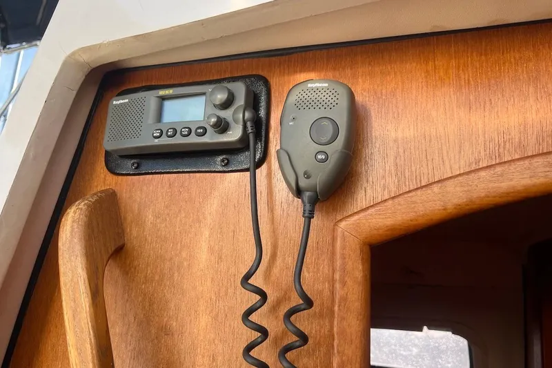 Slide: The Image of VHF radio and microphone on a 2002 Hunter 326 sailboat's wooden interior panel. - 24