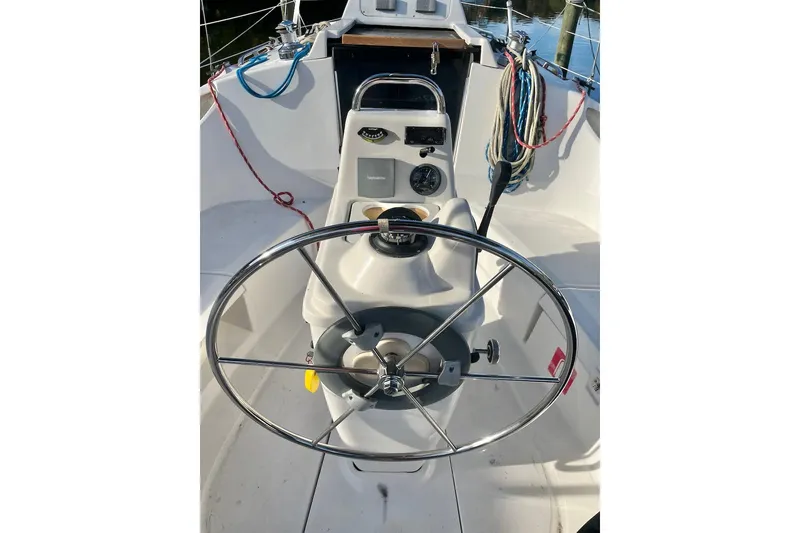 Slide: The Image of Cockpit of 2002 Hunter 326 sailboat with steering wheel and control panel. - 5