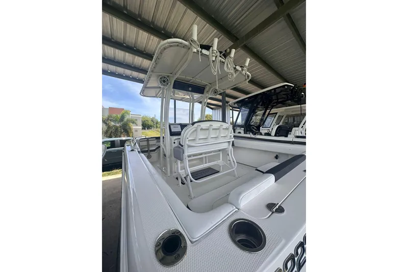 Slide: The Image of 2023 Robalo R222 Explorer boat interior with seating and console under a canopy. - 10