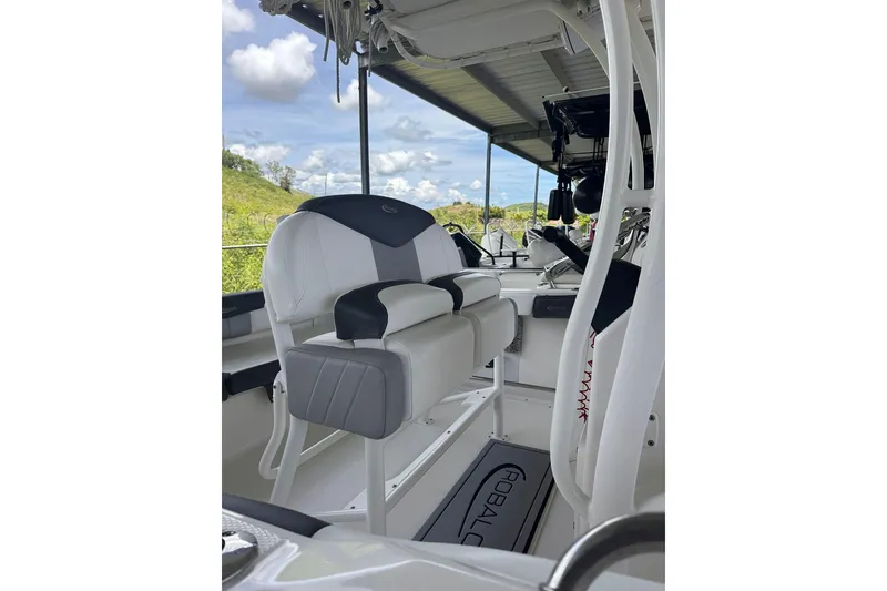 Slide: The Image of 2023 Robalo R222 Explorer boat interior with cushioned seating and steering console. - 12