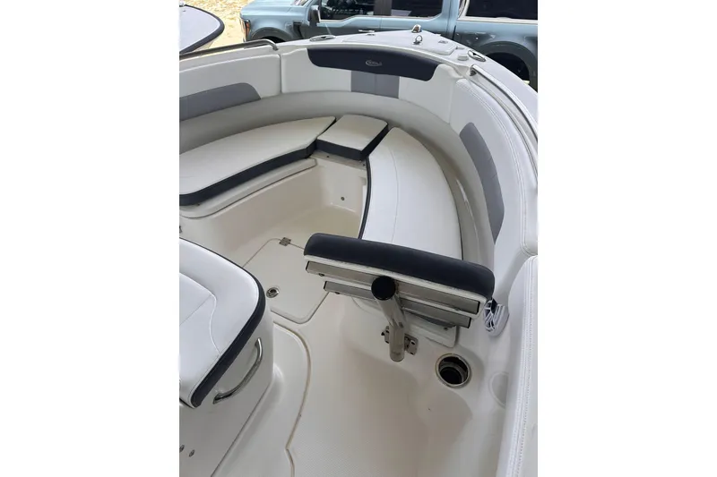 Slide: The Image of 2023 Robalo R222 Explorer boat interior with cushioned seating and storage. - 13