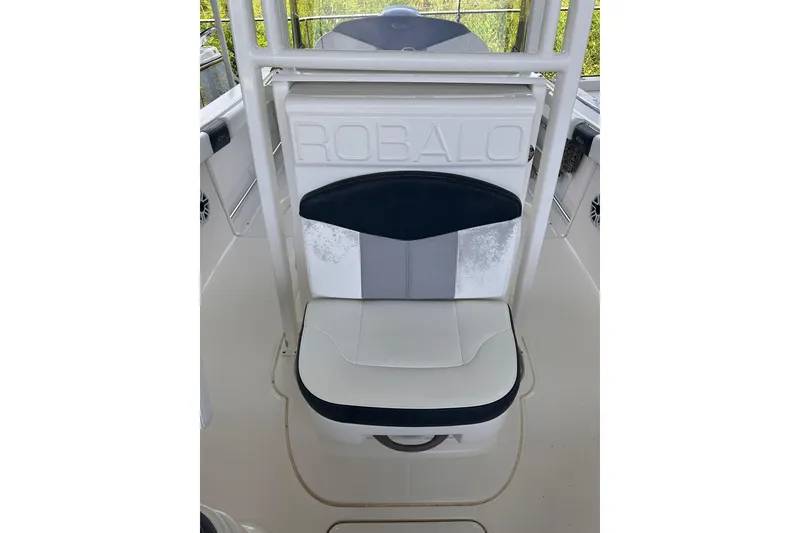 Slide: The Image of 2023 Robalo R222 Explorer boat seat with white and black upholstery. - 14