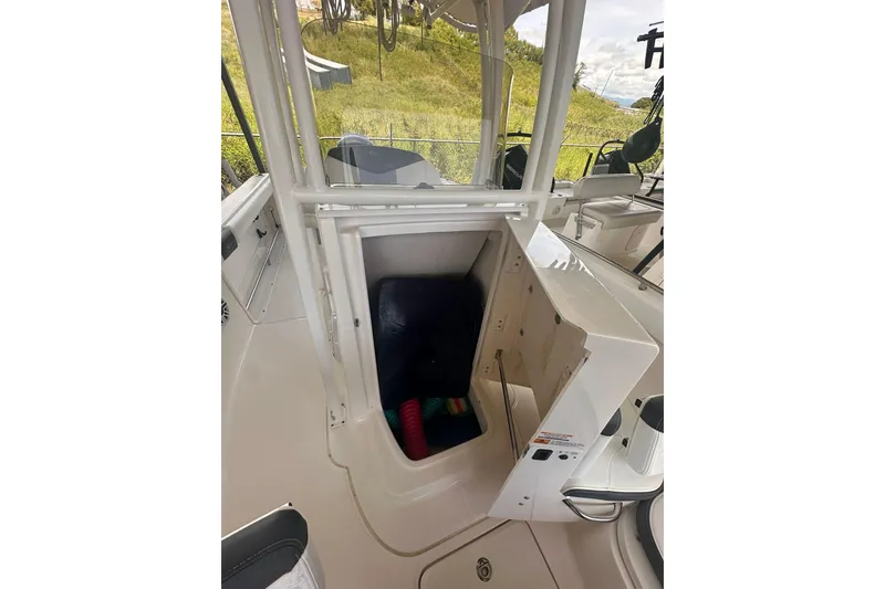 Slide: The Image of 2023 Robalo R222 Explorer boat interior storage compartment open. - 16