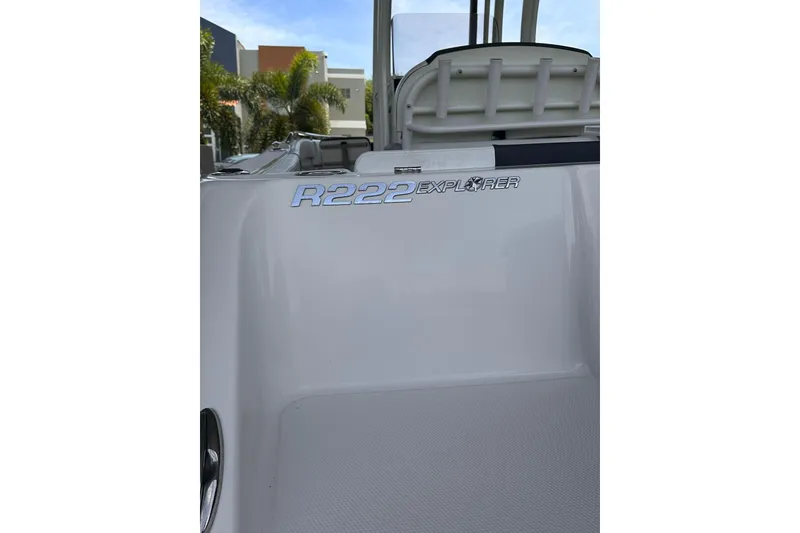 Slide: The Image of 2023 Robalo R222 Explorer boat, close-up of model name on sleek white surface. - 4