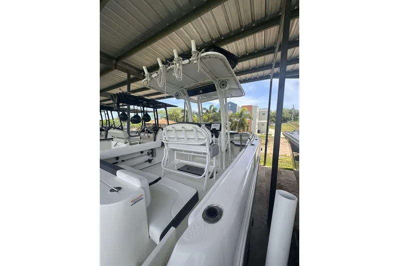 Slide: The Image of 2023 Robalo R222 Explorer boat under a metal canopy, showcasing seating and console. - 8