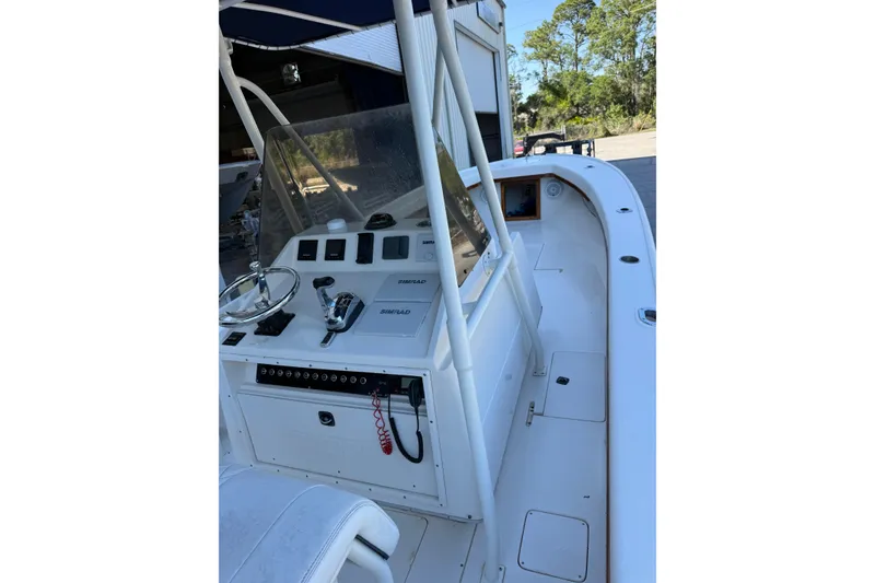Slide: The Image of 1993 Intrepid 26 Walkaround boat cockpit with steering wheel and control panel. - 6