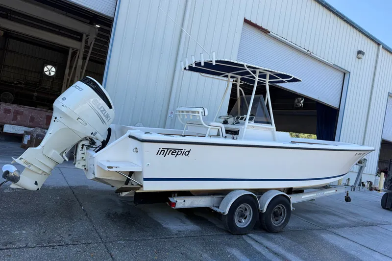 Slide: The Image of 1993 Intrepid 26 Walkaround boat on trailer with Suzuki outboard motor. - 8