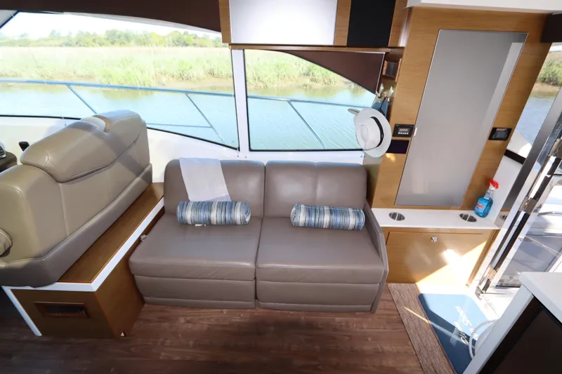 Slide: The Image of Interior of 2015 Cruisers Yachts 45 Cantius with leather sofa and panoramic window. - 16