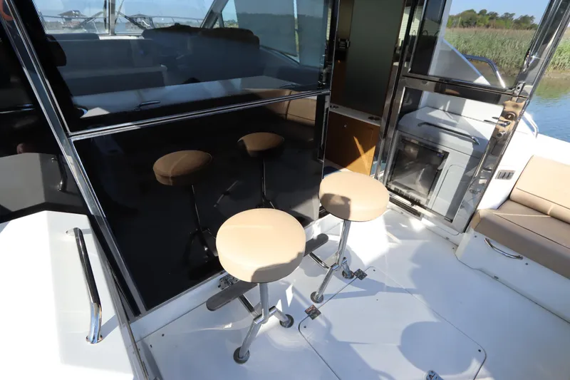 Slide: The Image of Interior of 2015 Cruisers Yachts 45 Cantius with bar stools. - 25