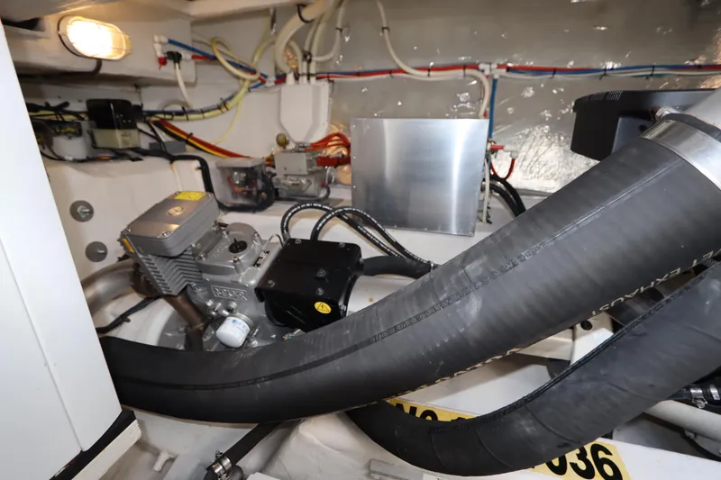 Slide: The Image of Engine room of 2015 Cruisers Yachts 45 Cantius with hoses and wiring. - 48