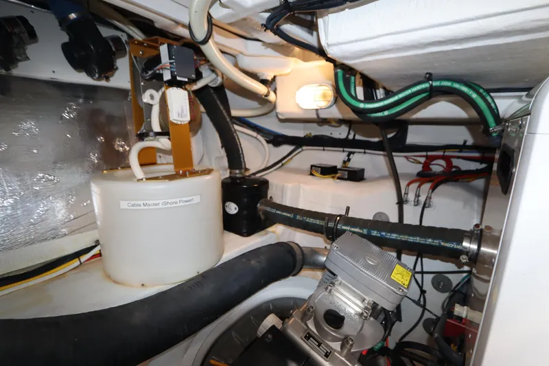 Slide: The Image of Engine room of 2015 Cruisers Yachts 45 Cantius with hoses and components. - 49